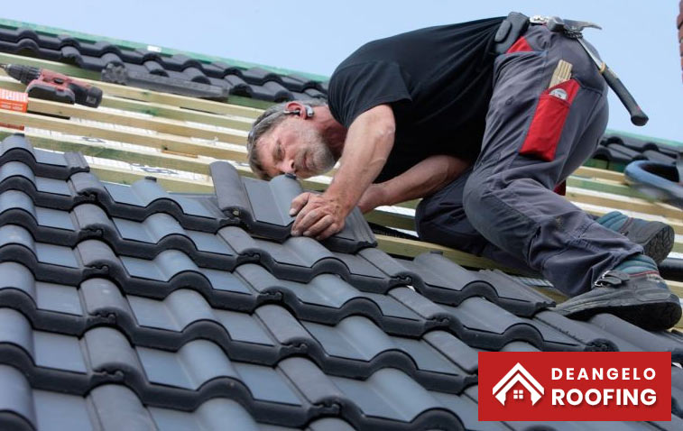 Contractor inspecting a roof during a replacement project.