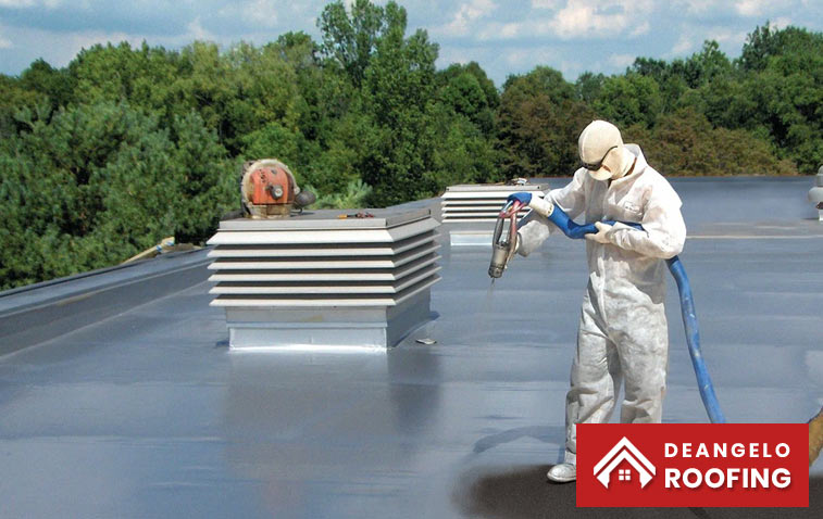 Workers applying a protective commercial roof coating to enhance durability and energy efficiency